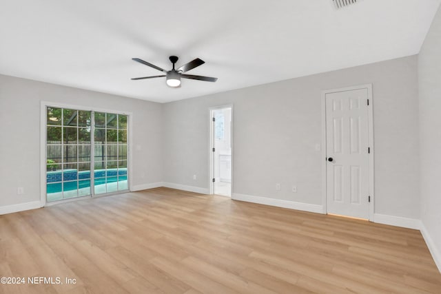 empty room with ceiling fan and light wood-type flooring