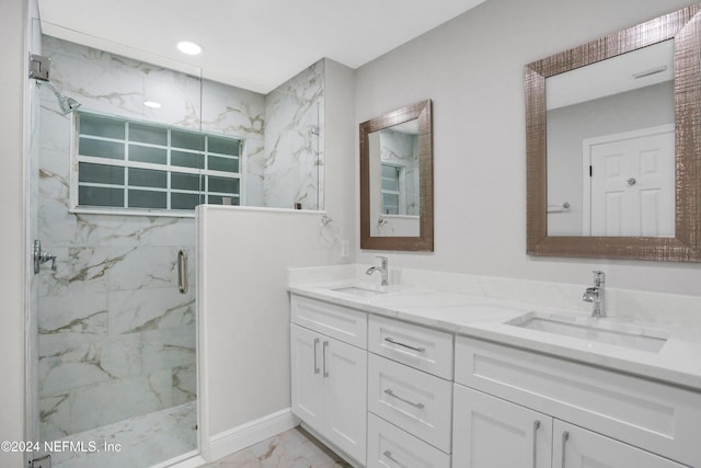 bathroom with vanity and a shower with door