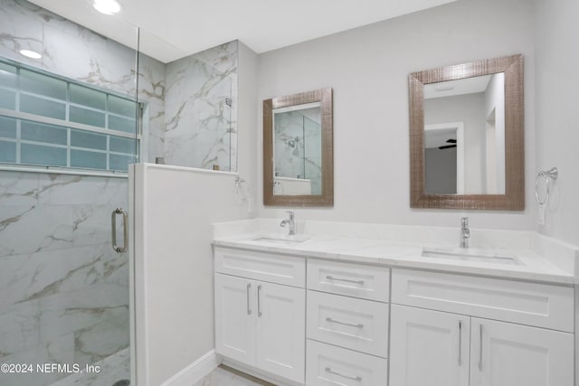 bathroom featuring vanity, ceiling fan, and a shower with shower door