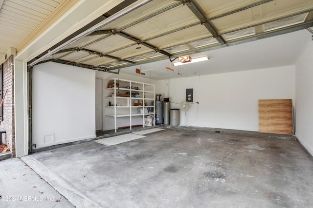 garage with electric panel, a garage door opener, and water heater