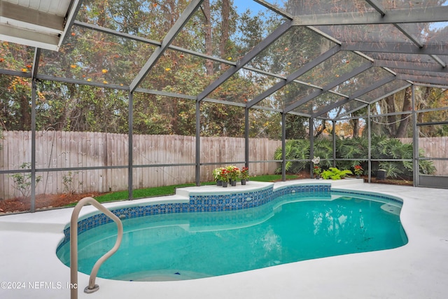 view of swimming pool with glass enclosure