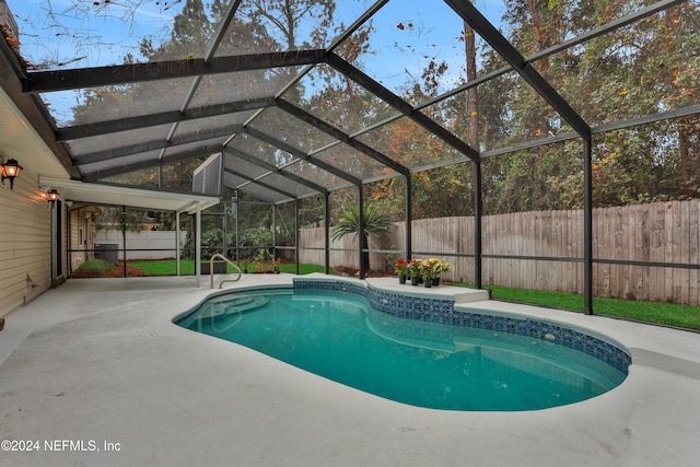 view of swimming pool with a patio area and a lanai