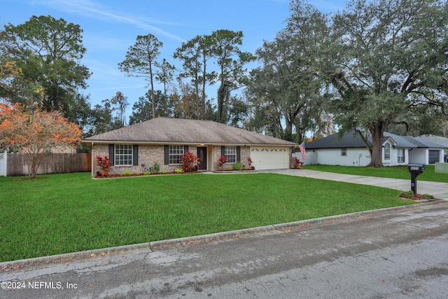 single story home with a garage and a front yard