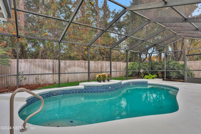 view of swimming pool with glass enclosure