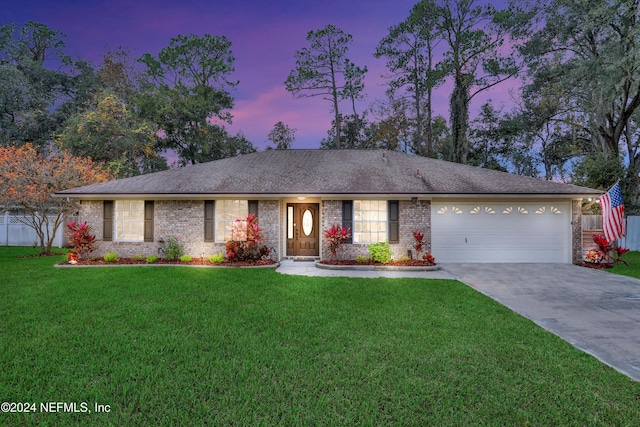 ranch-style house with a lawn and a garage