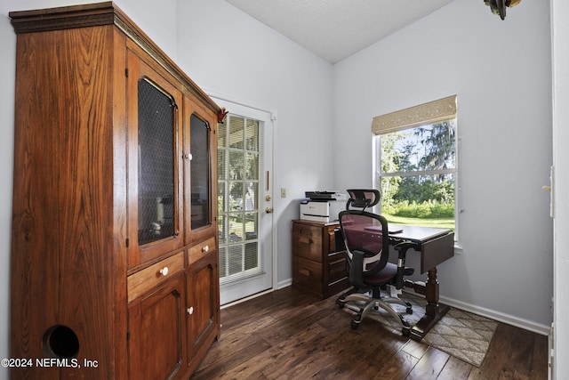 home office featuring dark hardwood / wood-style floors and a textured ceiling