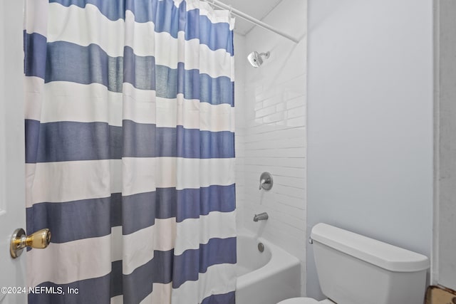 bathroom with toilet and shower / bath combo with shower curtain