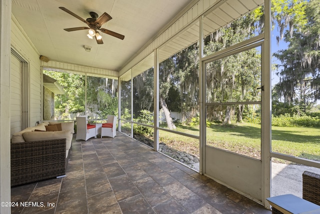 sunroom / solarium featuring ceiling fan and a wealth of natural light