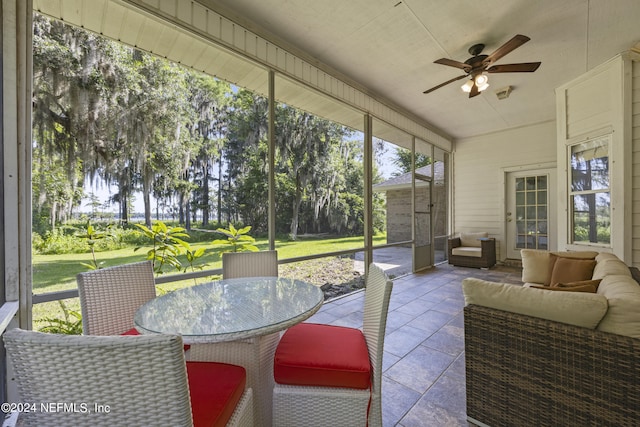 sunroom / solarium with ceiling fan and a healthy amount of sunlight