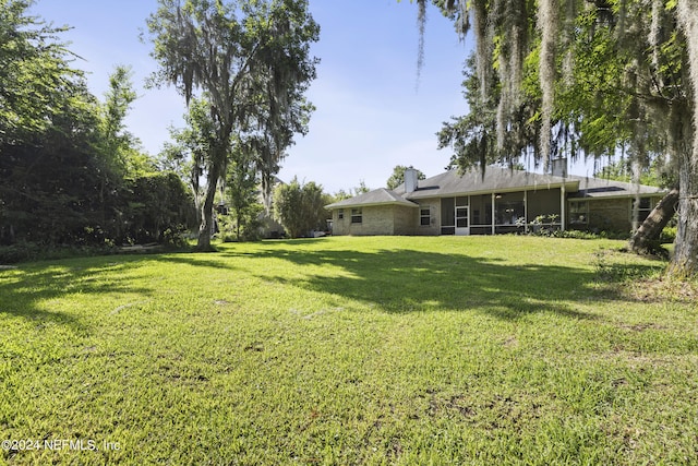 view of yard featuring a sunroom