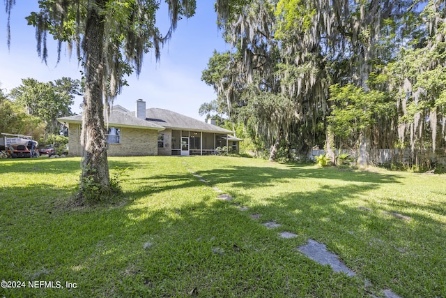 view of yard featuring a sunroom