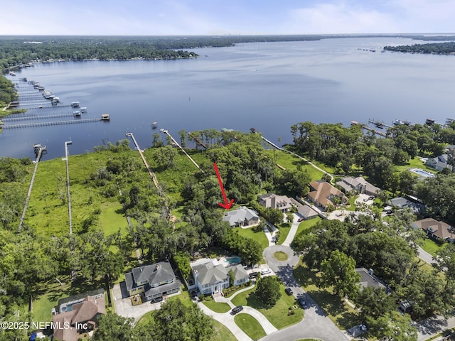 drone / aerial view featuring a residential view and a water view