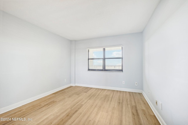 unfurnished room with light hardwood / wood-style floors