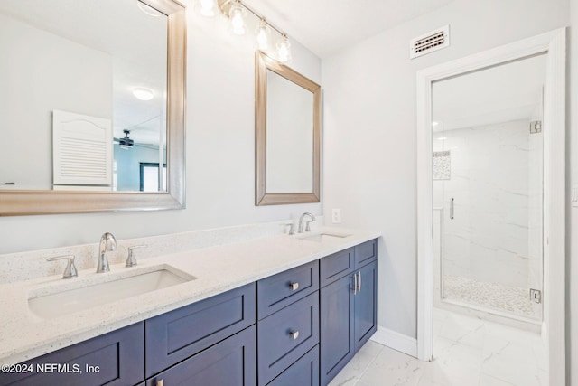 bathroom featuring ceiling fan, a shower with door, and vanity