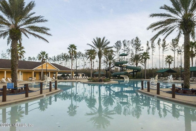 view of swimming pool with a water slide