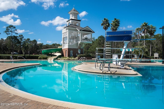 view of swimming pool featuring a patio and a water slide