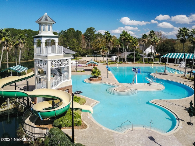 view of pool featuring a patio area and a water slide