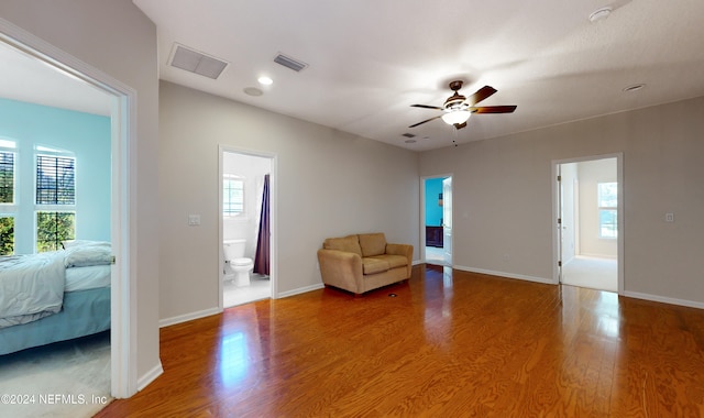 unfurnished room with ceiling fan, a healthy amount of sunlight, and hardwood / wood-style flooring