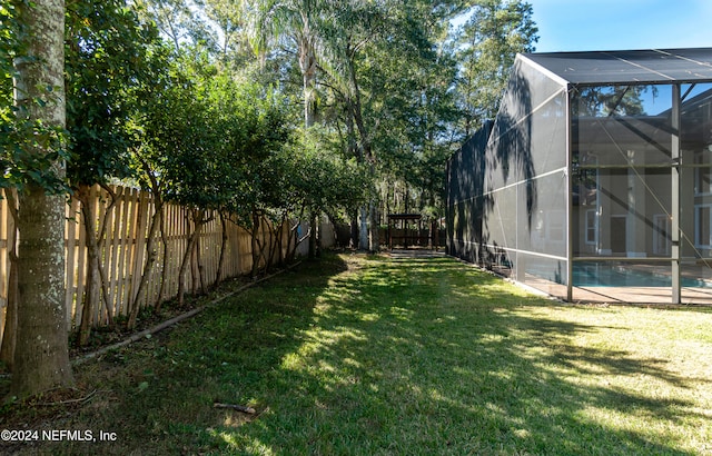 view of yard featuring a fenced in pool and a lanai