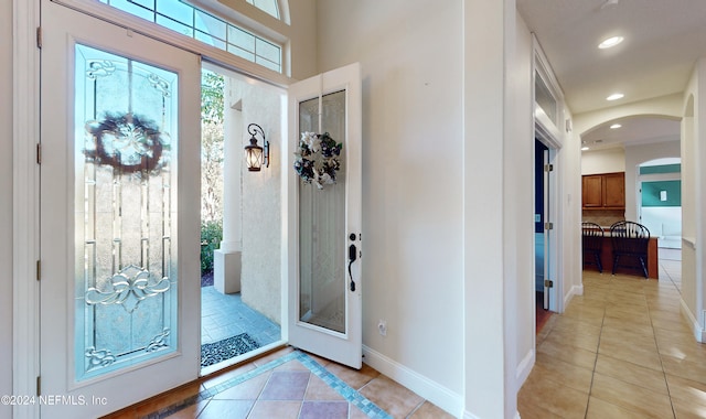 entryway with light tile patterned flooring