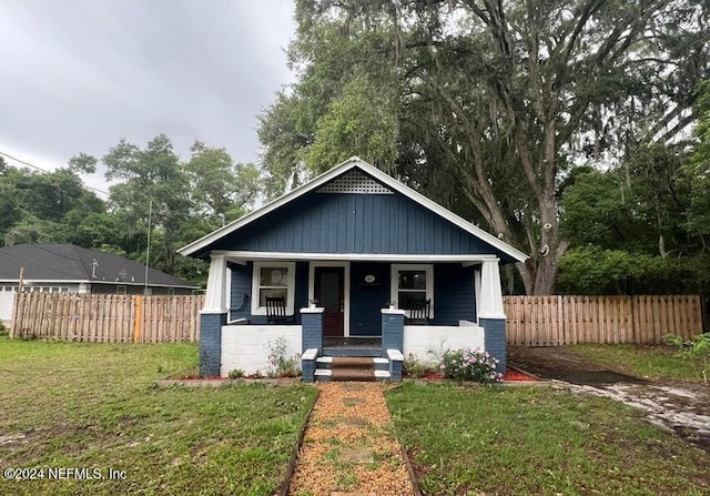 bungalow-style home featuring a front lawn