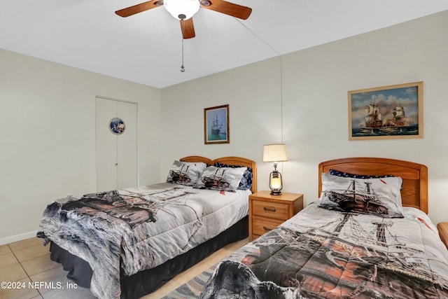 bedroom with ceiling fan and light tile patterned flooring