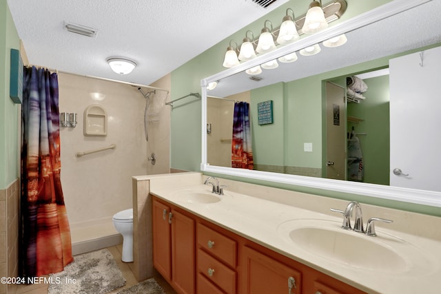 bathroom featuring toilet, tile patterned floors, a textured ceiling, and curtained shower