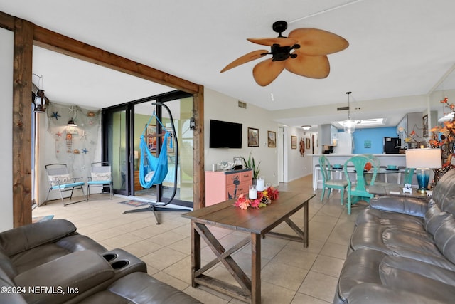 tiled living room featuring ceiling fan, a healthy amount of sunlight, and beam ceiling