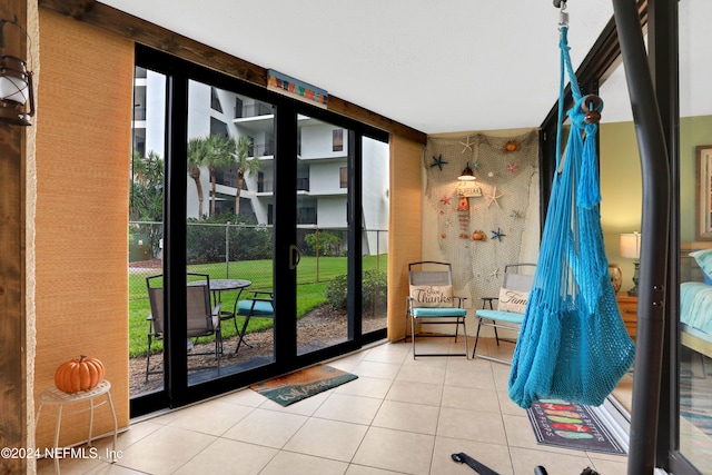 doorway featuring light tile patterned floors and plenty of natural light