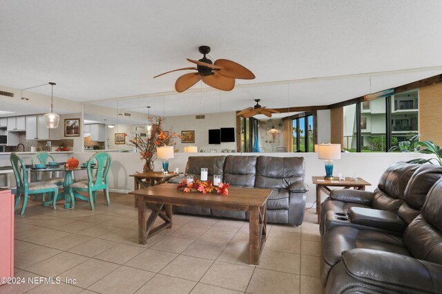 living room featuring ceiling fan and light tile patterned floors