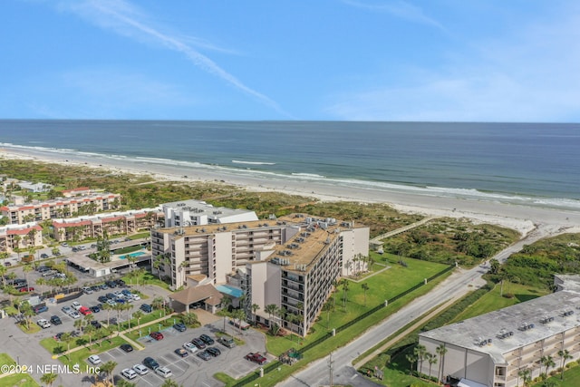 birds eye view of property featuring a beach view and a water view