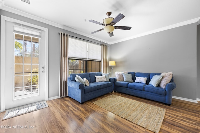 living room with dark hardwood / wood-style flooring, ceiling fan, and crown molding