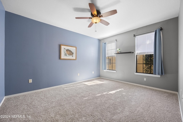 carpeted spare room featuring ceiling fan