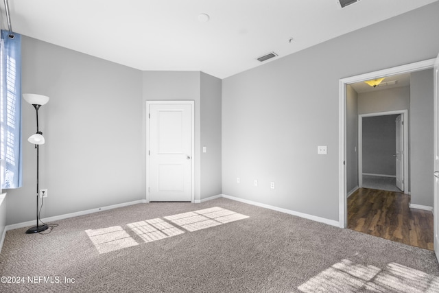 unfurnished room with dark carpet