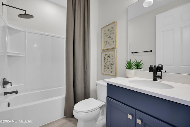 full bathroom with hardwood / wood-style floors, vanity, toilet, and shower / tub combo with curtain