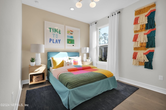 bedroom with hardwood / wood-style flooring