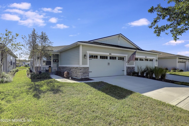 view of front of property with a garage and a front lawn