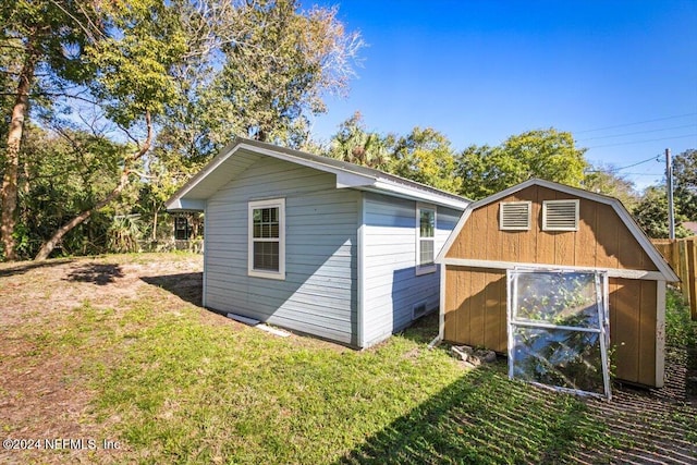 view of outbuilding with a lawn