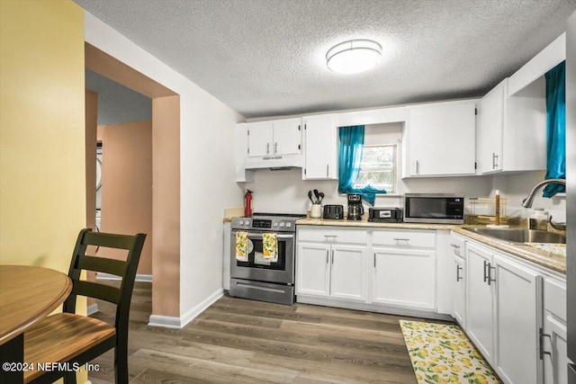 kitchen featuring white cabinets, stainless steel appliances, hardwood / wood-style flooring, and sink