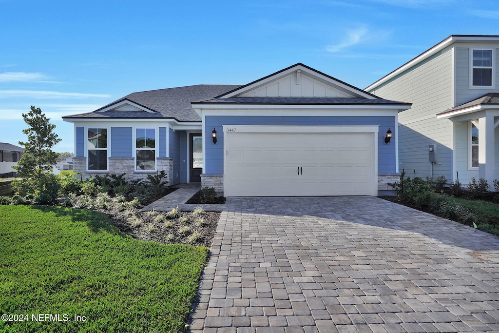 3447 Kindlewood Dr, Middleburg, FL 32068 - view of front of property featuring a front lawn and a garage