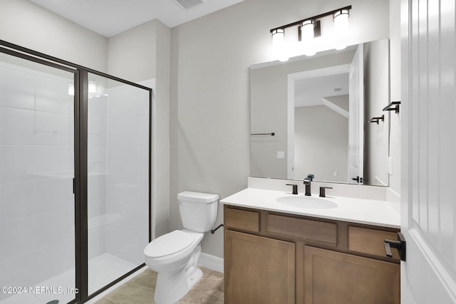 bathroom with vanity, a shower with shower door, and toilet