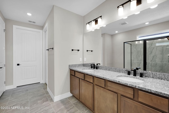 bathroom with vanity and a shower with shower door