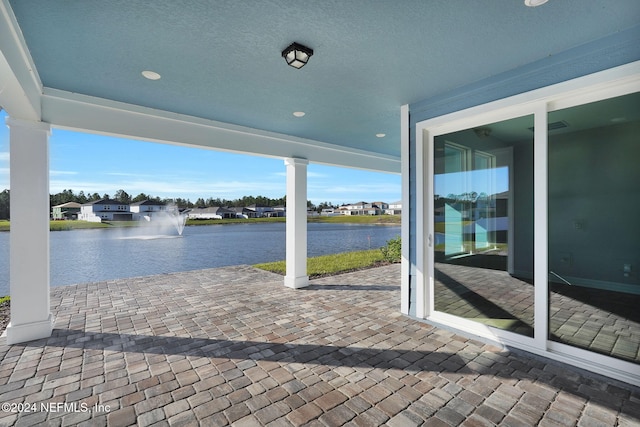 view of patio featuring a water view