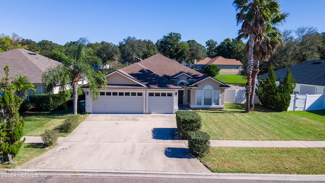 view of front of house with a front lawn and a garage