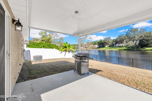 view of patio featuring grilling area and a water view