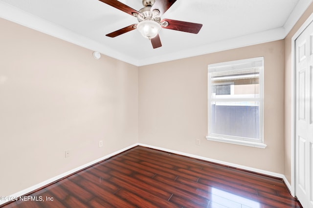 unfurnished room featuring ceiling fan, dark hardwood / wood-style floors, and ornamental molding