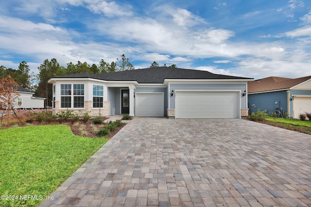 view of front facade with a front yard and a garage