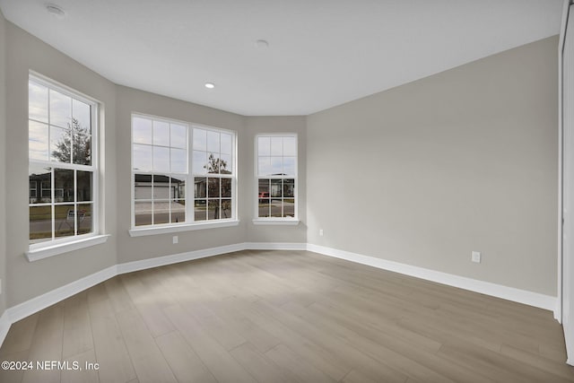 unfurnished room with light wood-type flooring