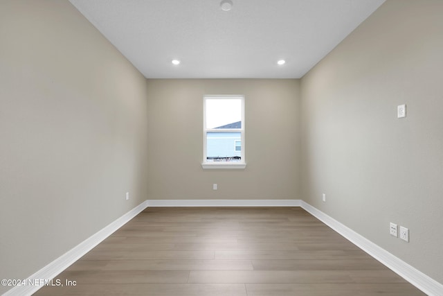 empty room with hardwood / wood-style floors