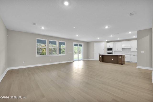 unfurnished living room with light hardwood / wood-style flooring